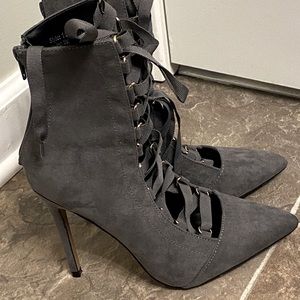 Gray lace up faux suede heeled ankle boots.